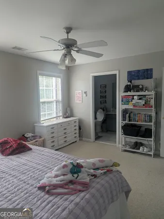 a bedroom with a large bed and a window