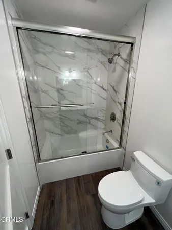 a bathroom with a toilet and a shower