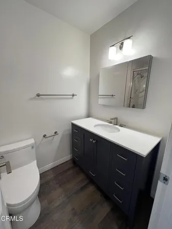 a spacious bathroom with a double vanity sink toilet and a mirror