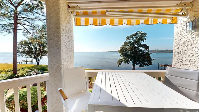 a view of a balcony with table and chairs and wooden floor