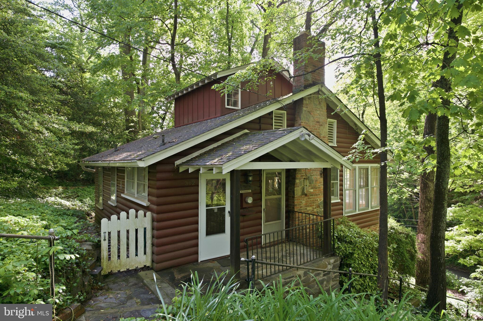 362 Severn Road Annapolis, MD 21401 - Photo 6 of 42 Charming cabin nestled in lush greenery.