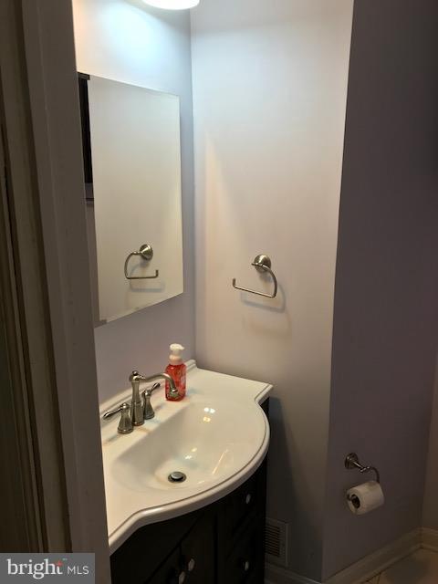 1704 Leslie Road Baltimore, MD 21222 - Photo 11 of 24 a bathroom with a sink and a mirror