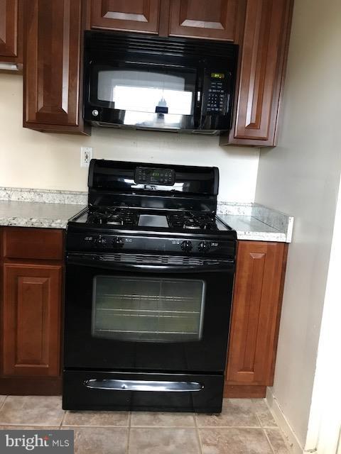 1704 Leslie Road Baltimore, MD 21222 - Photo 14 of 24 a stove top oven sitting inside of a kitchen and granite counter tops