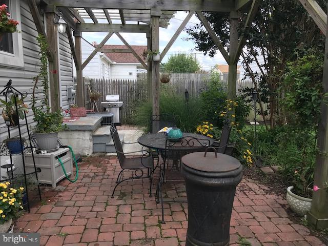 1704 Leslie Road Baltimore, MD 21222 - Photo 20 of 24 a view of a patio with table and chairs potted plants and a fountain