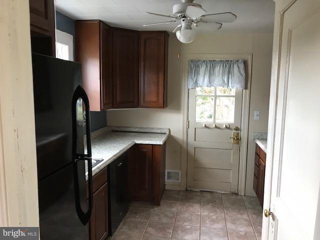 1704 Leslie Road Baltimore, MD 21222 - Photo 2 of 24 a kitchen with a refrigerator and a sink