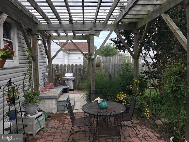 1704 Leslie Road Baltimore, MD 21222 - Photo 21 of 24 a patio with a table and chairs and a barbeque