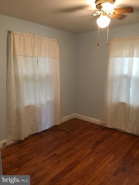 1704 Leslie Road Baltimore, MD 21222 - Photo 3 of 24 a view of an empty room with wooden floor and a chandelier