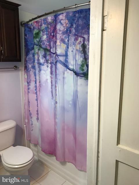 1704 Leslie Road Baltimore, MD 21222 - Photo 10 of 24 a white toilet sitting next to a shower curtain