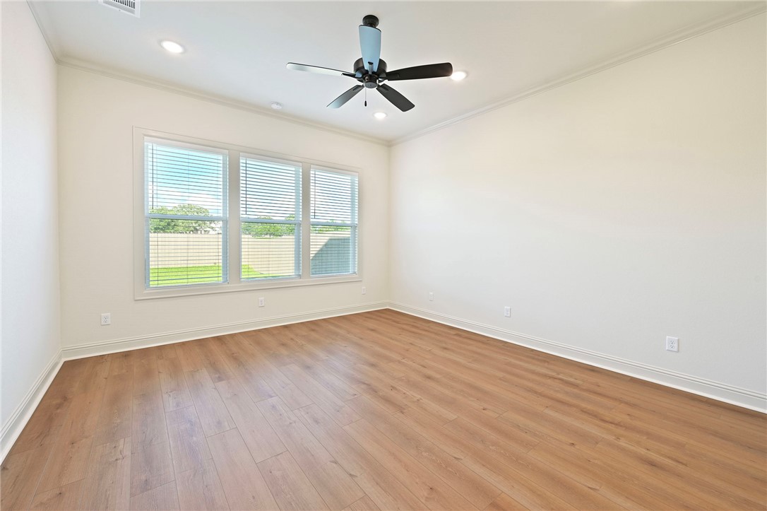 7052 Skipping Rock Path Bryan, TX 77808 - Photo 10 of 23 wooden floor in an empty room with a window