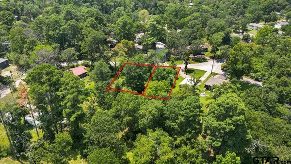 an aerial view of house with yard and outdoor seating