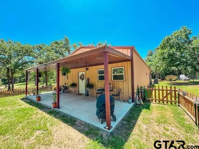 a view of a house with a backyard porch and sitting area