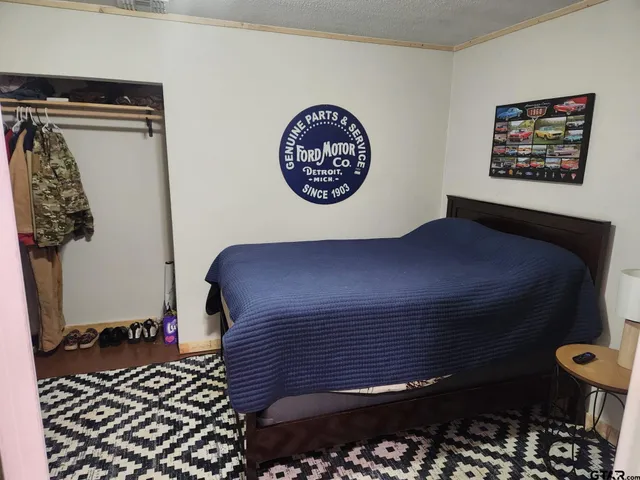 a bedroom with a bed and a table in it