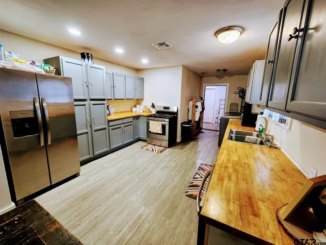 a kitchen with sink refrigerator and microwave