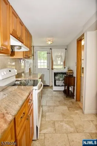 a large kitchen with a table and chairs