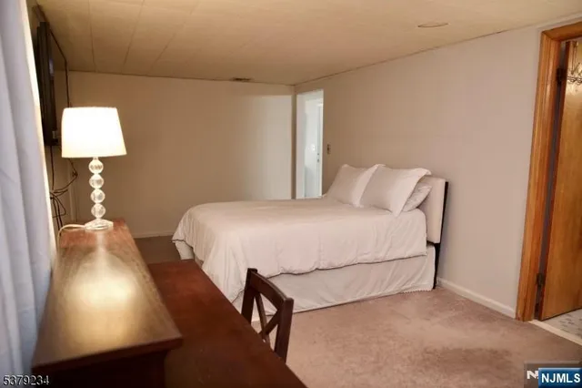 a bedroom with a bed and a lamp on table