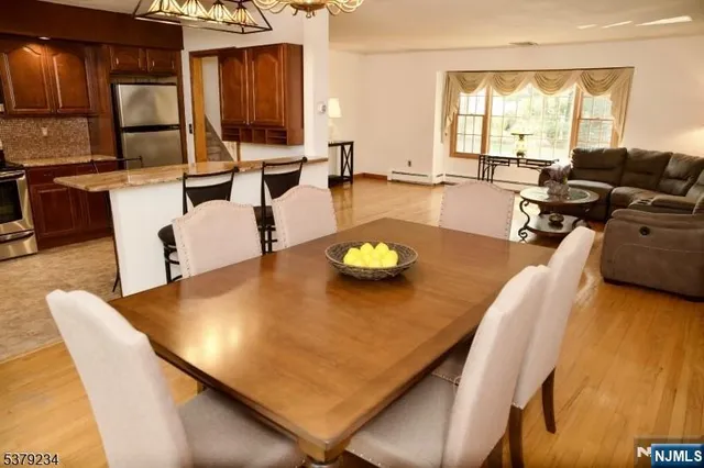 a view of a dining room with furniture and a large window