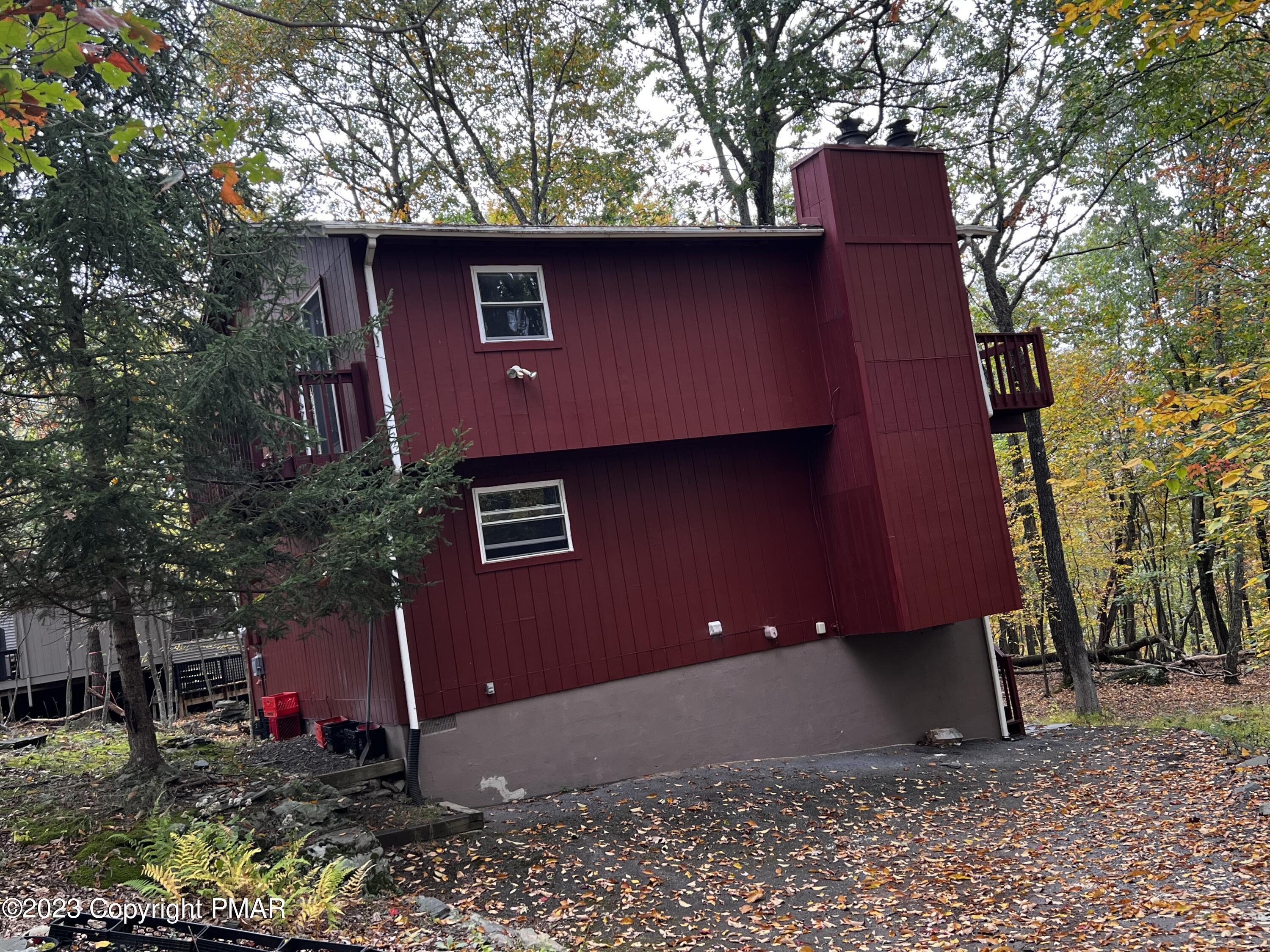 a red brick house with trees in front of it