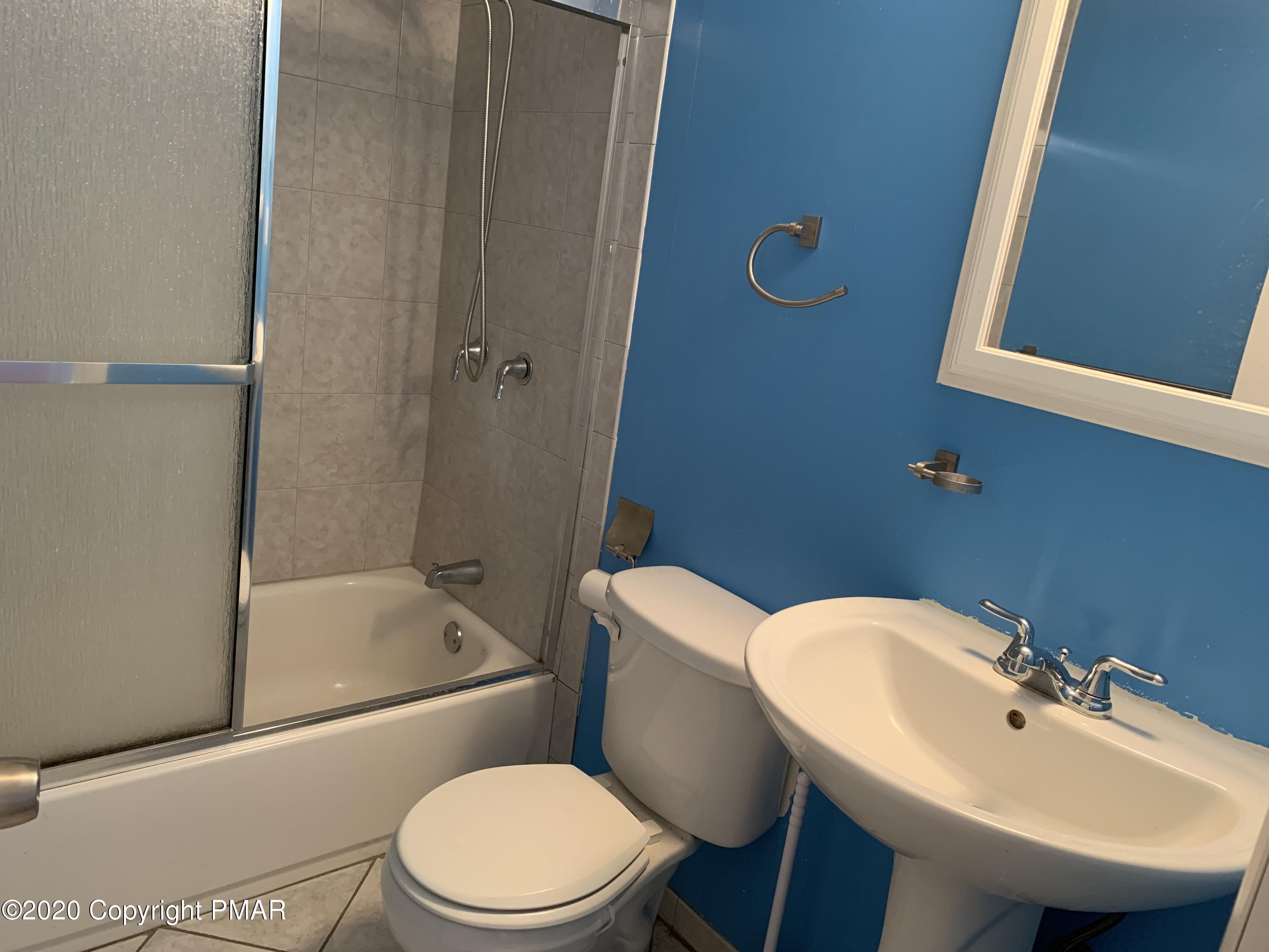 124 Saunders Drive Bushkill, PA 18324 - Photo 14 of 43 a bathroom with a sink a toilet and shower