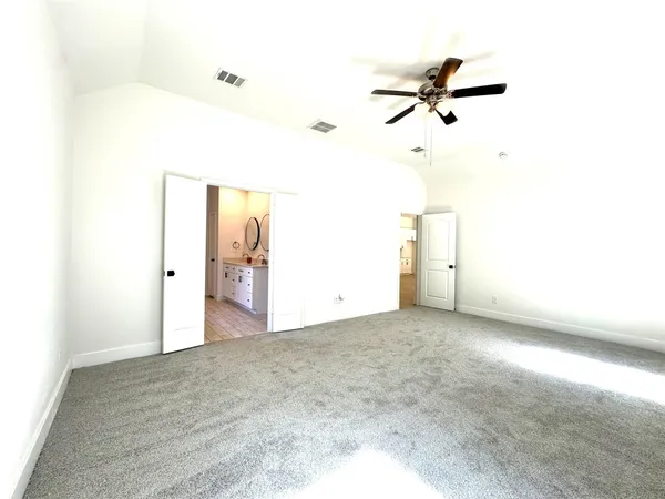 a view of a room with a ceiling fan