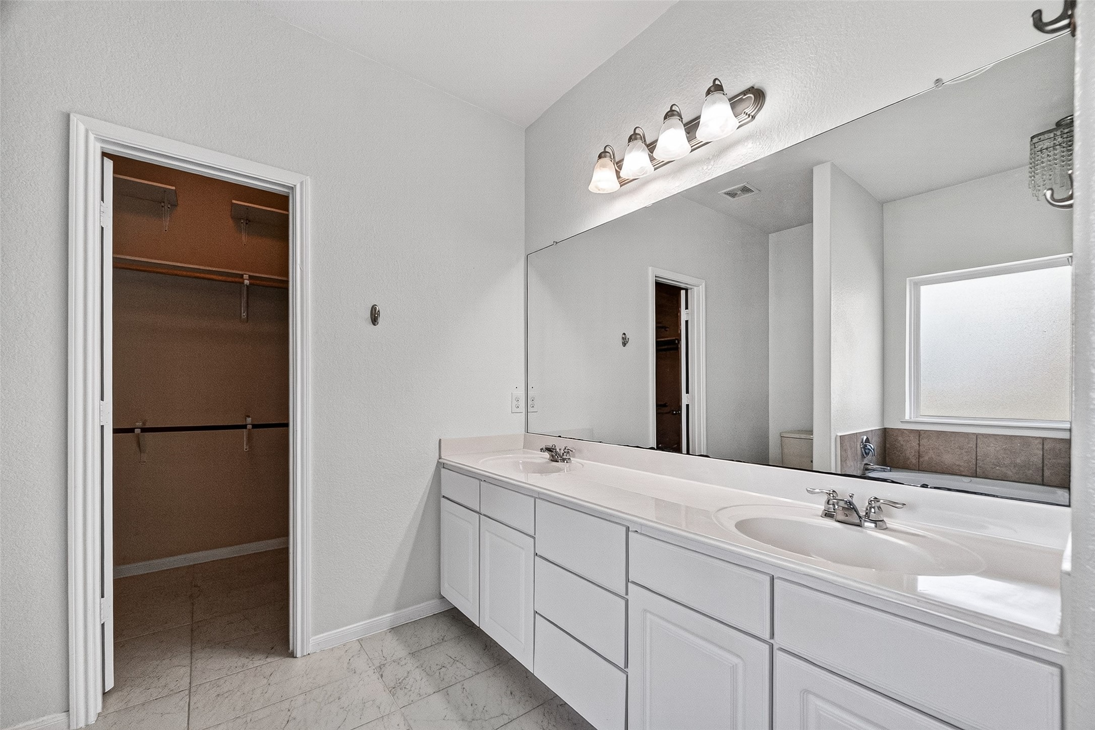 2702 Modano Court Fresno, TX 77545 - Photo 16 of 46 a bathroom with a double vanity sink and mirror