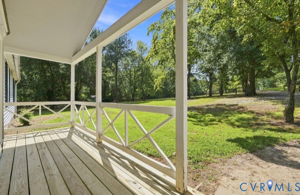 977 Burchs Mill Road Urbanna, VA 23175 - Photo 3 of 38 Covered front porch with wood flooring, white rail