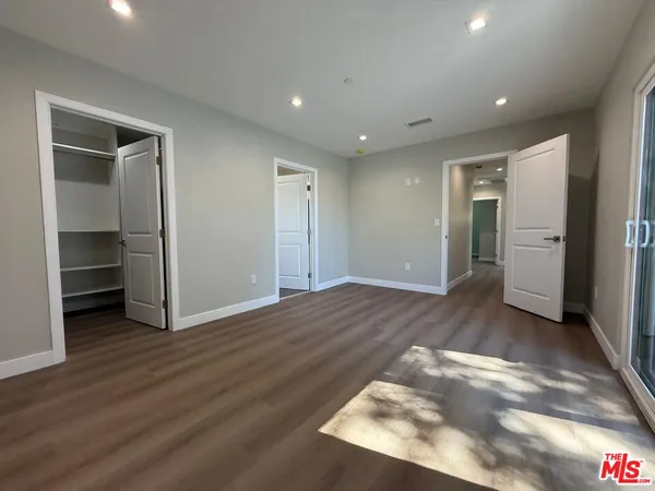 a view of a livingroom with wooden floor and closet