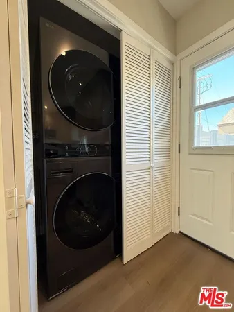 a living room with a washer and dryer