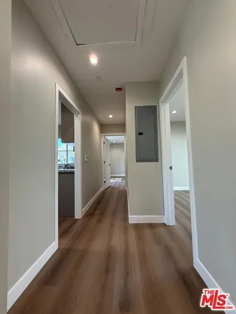 a view of hallway with wooden floor