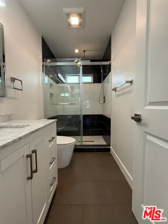 a bathroom with a sink a toilet and a shower