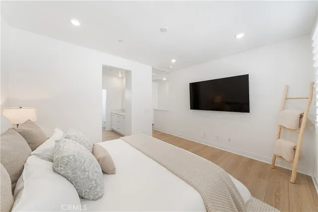 a bedroom with a bed and a flat screen tv