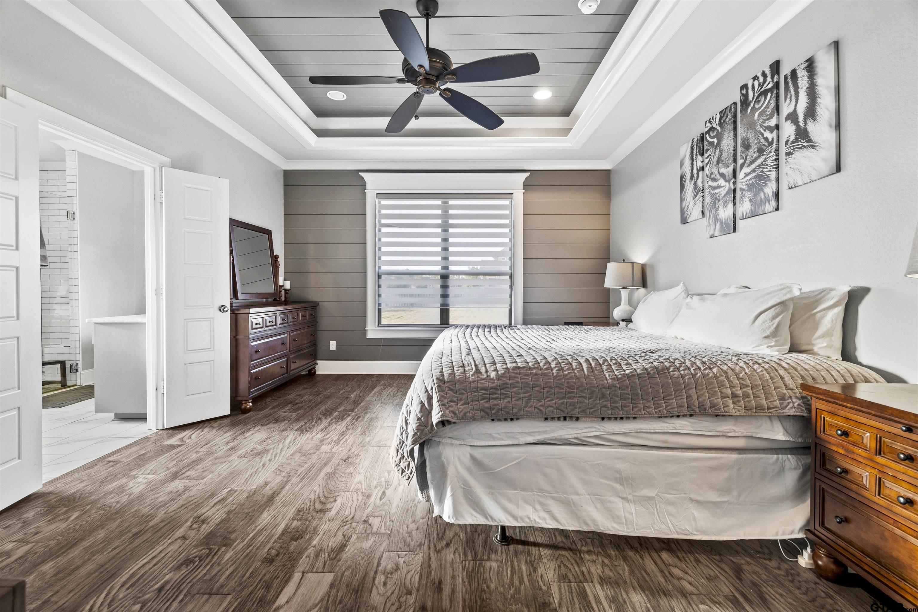 425 Coventry Street Bullard, TX 75757 - Photo 11 of 35 a spacious bedroom with a bed and a ceiling fan