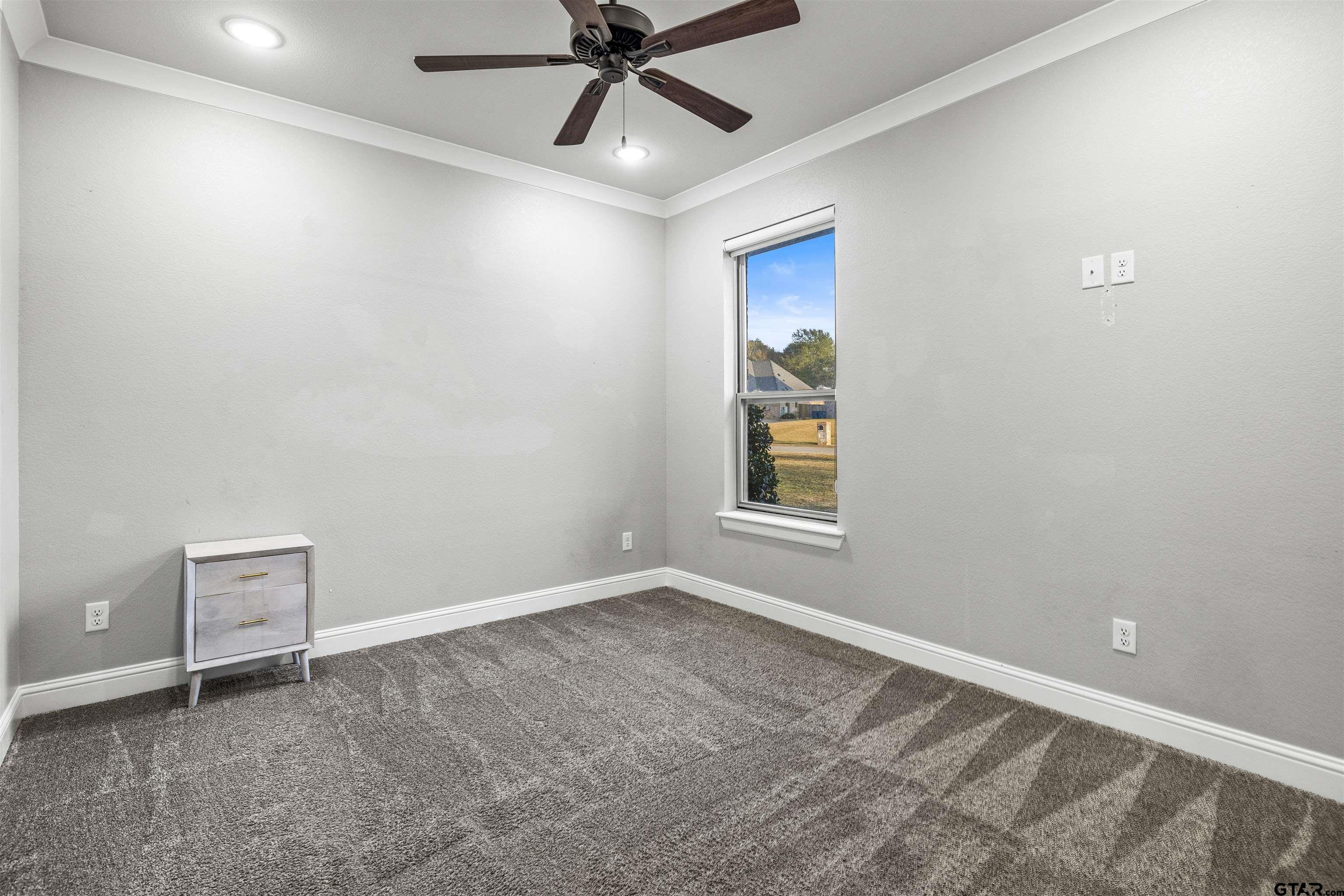 425 Coventry Street Bullard, TX 75757 - Photo 19 of 35 an empty room with windows and fan