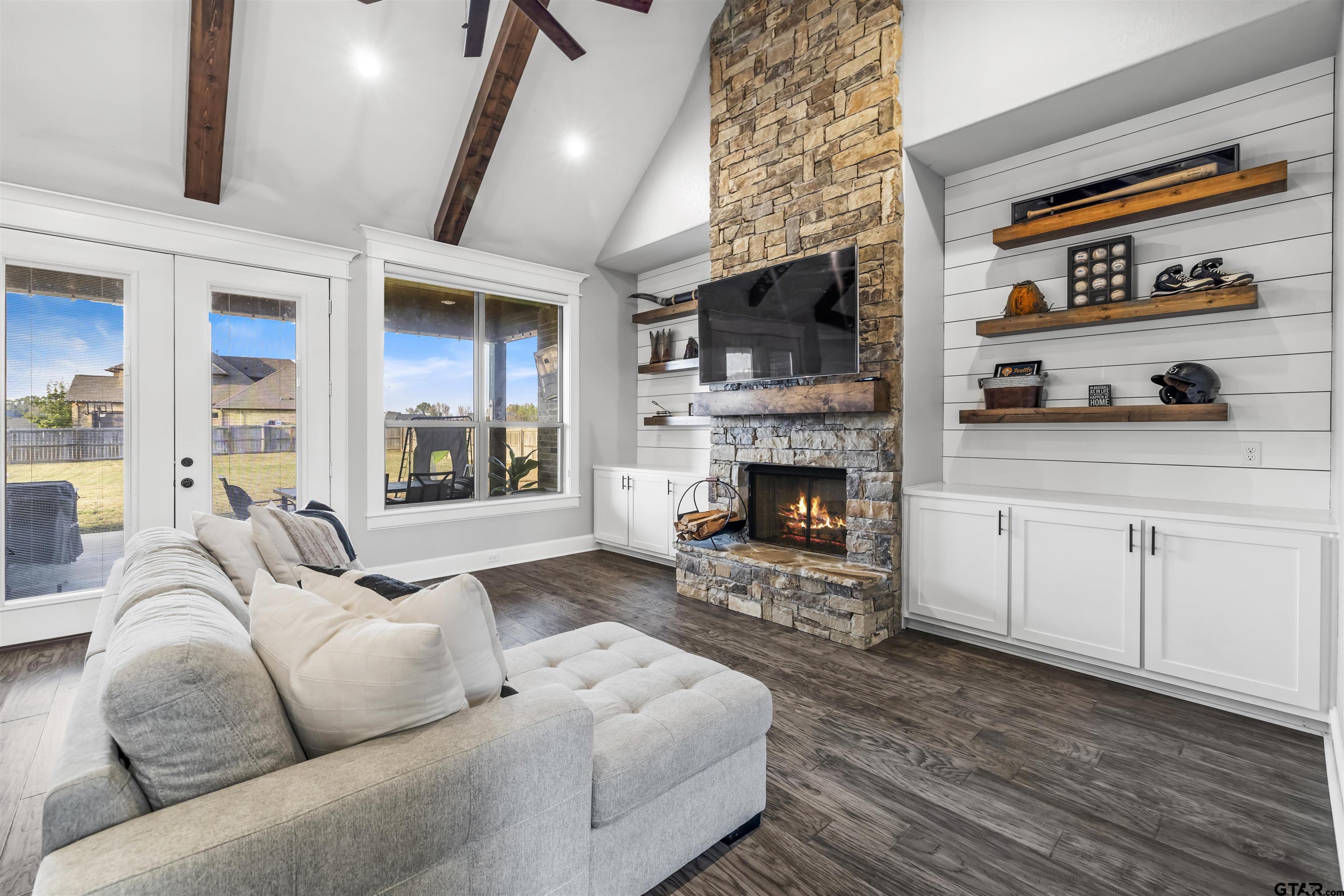 425 Coventry Street Bullard, TX 75757 - Photo 2 of 35 a living room with furniture a flat screen tv and a fireplace