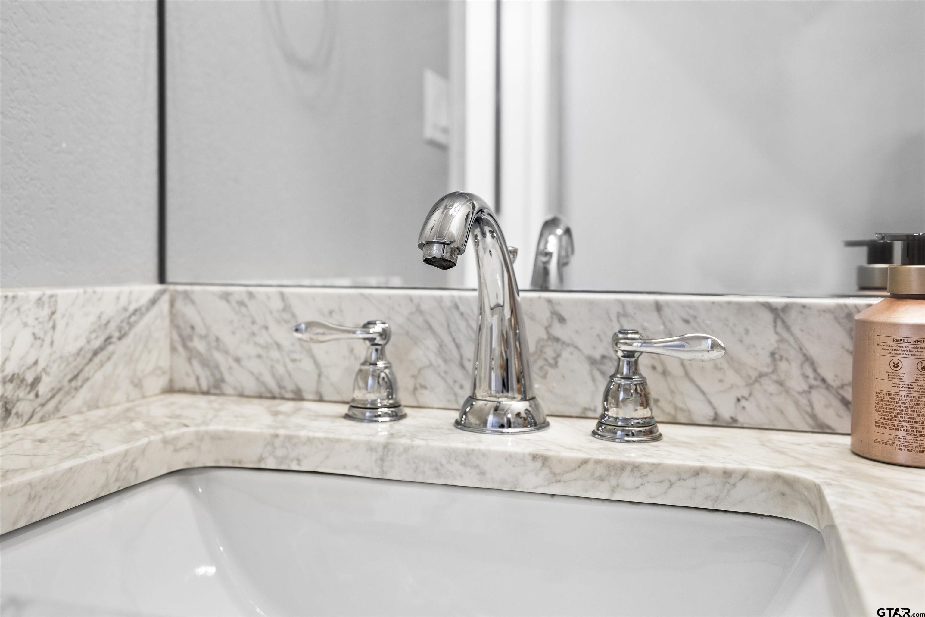 425 Coventry Street Bullard, TX 75757 - Photo 25 of 35 a bathroom with a granite countertop sink and a mirror