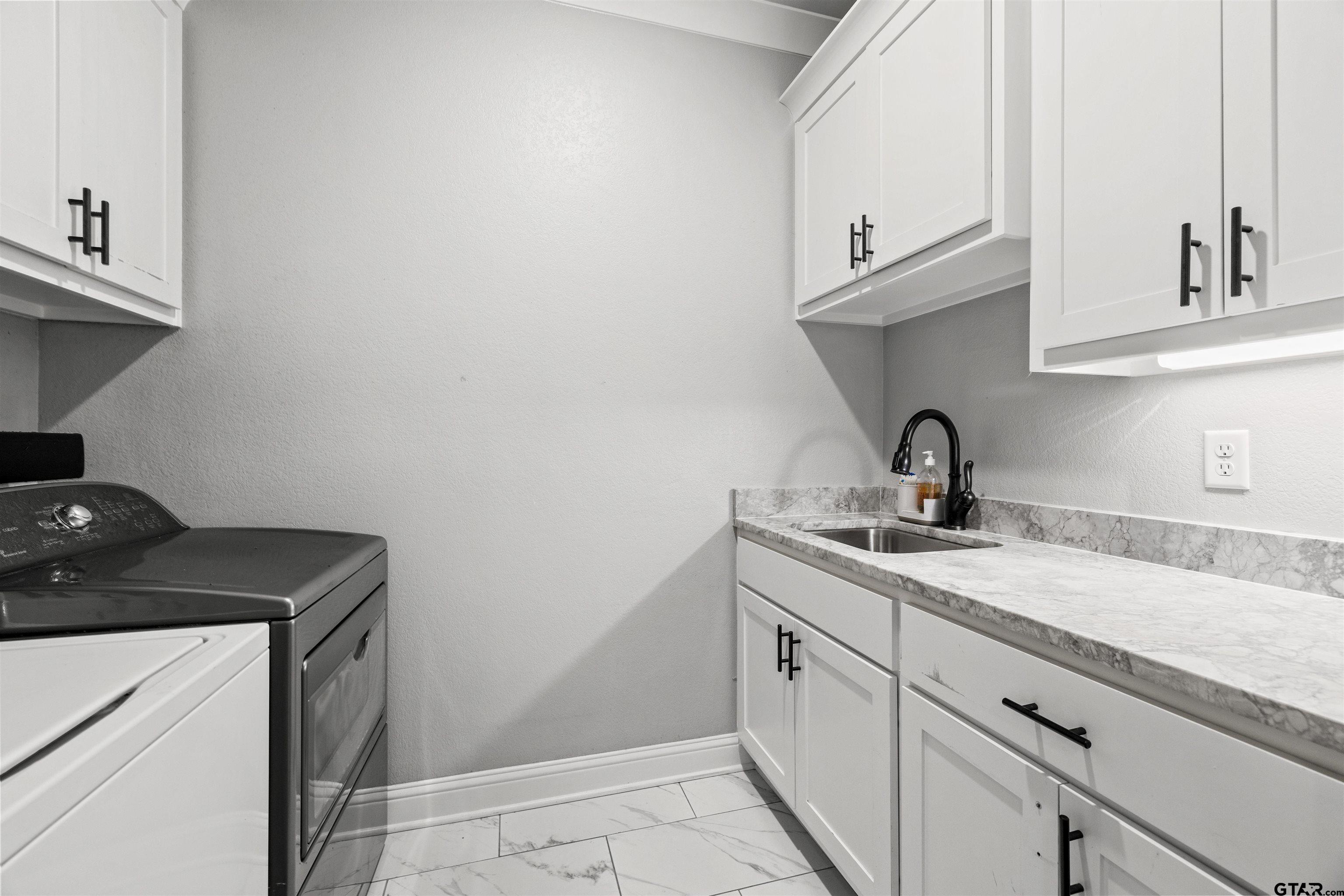425 Coventry Street Bullard, TX 75757 - Photo 27 of 35 a kitchen with a sink and cabinets