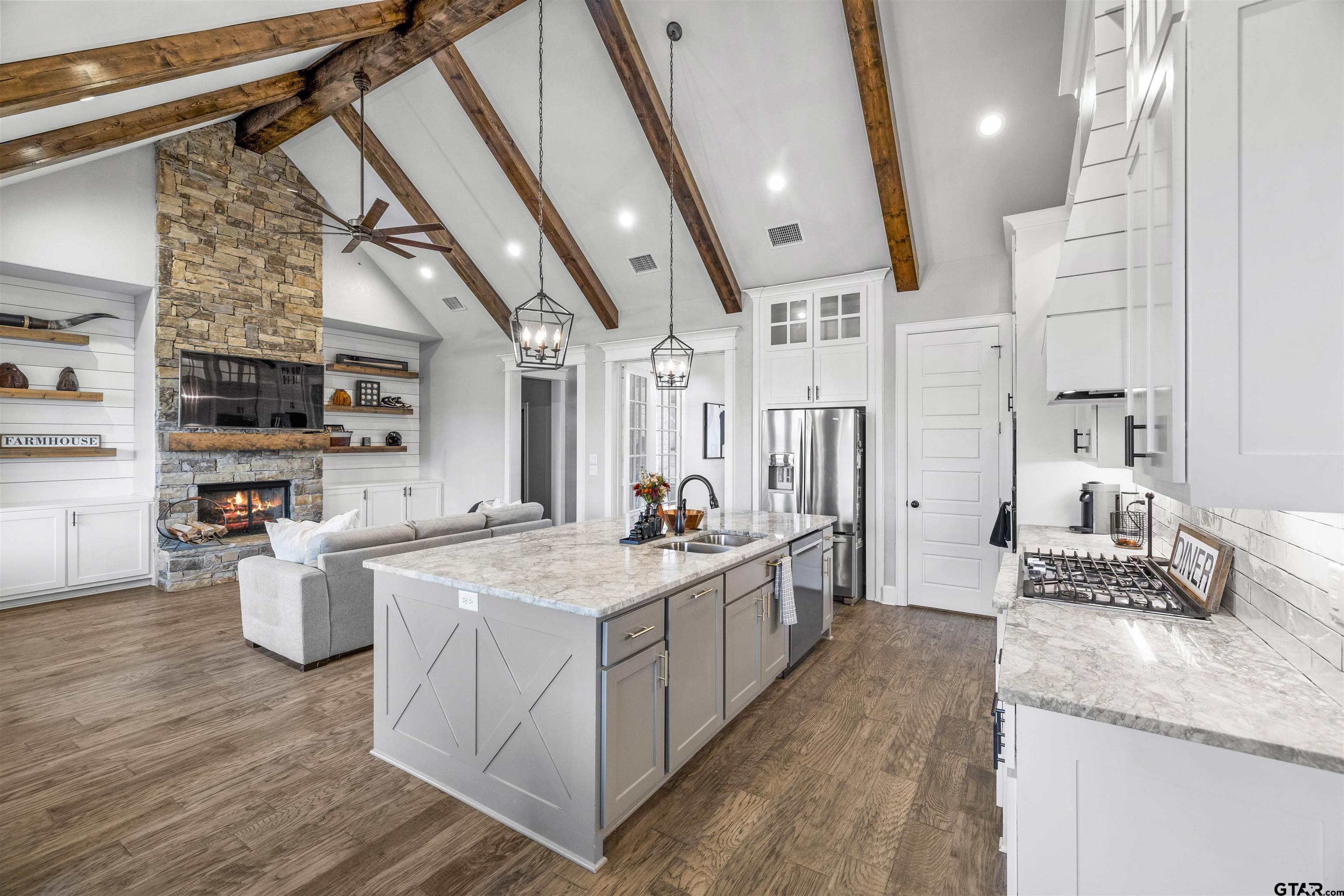 425 Coventry Street Bullard, TX 75757 - Photo 3 of 35 a large kitchen with stainless steel appliances kitchen island granite countertop a lot of counter space and wooden floors