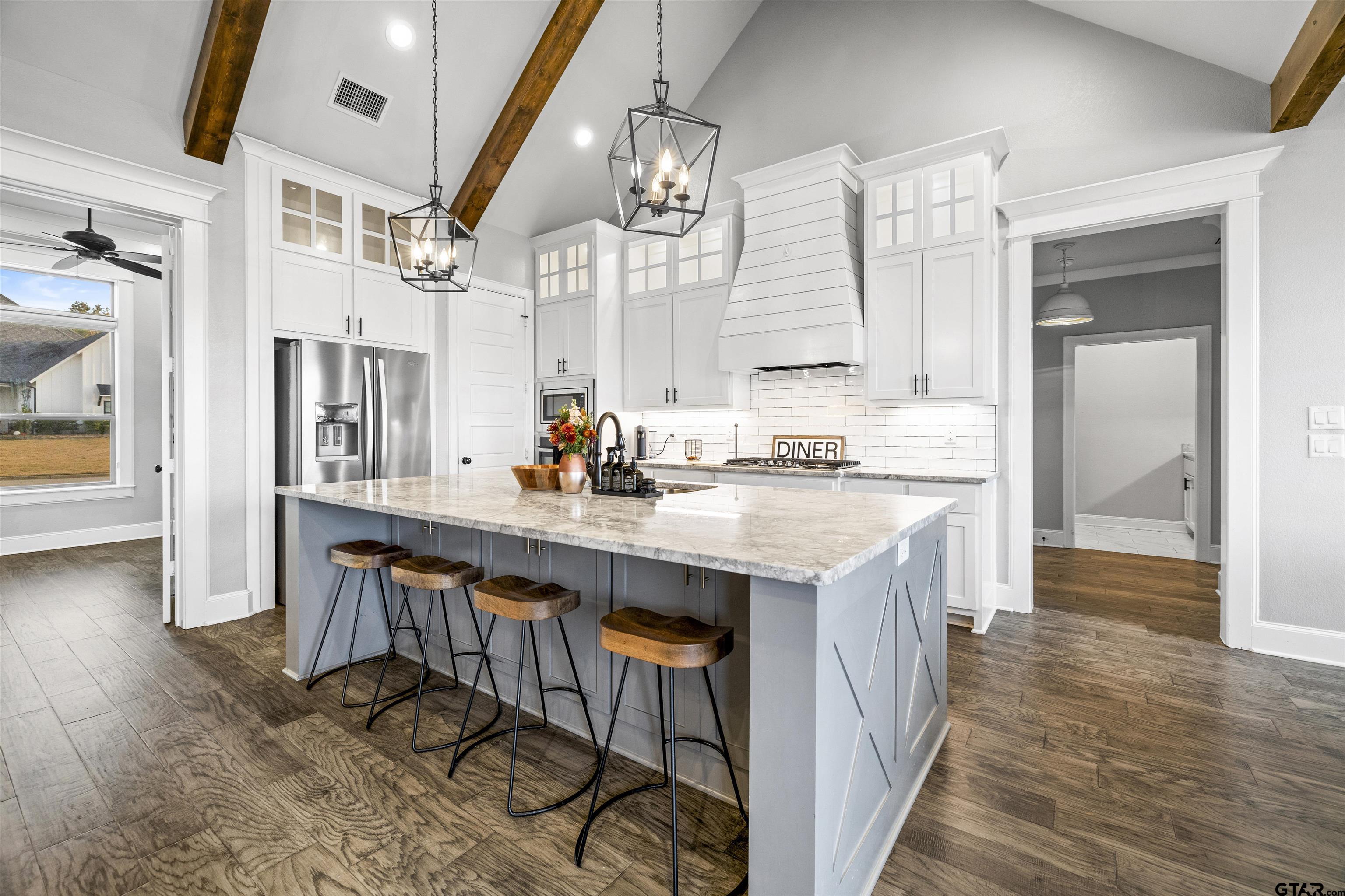 425 Coventry Street Bullard, TX 75757 - Photo 5 of 35 a kitchen with stainless steel appliances granite countertop a sink stove and wooden floor