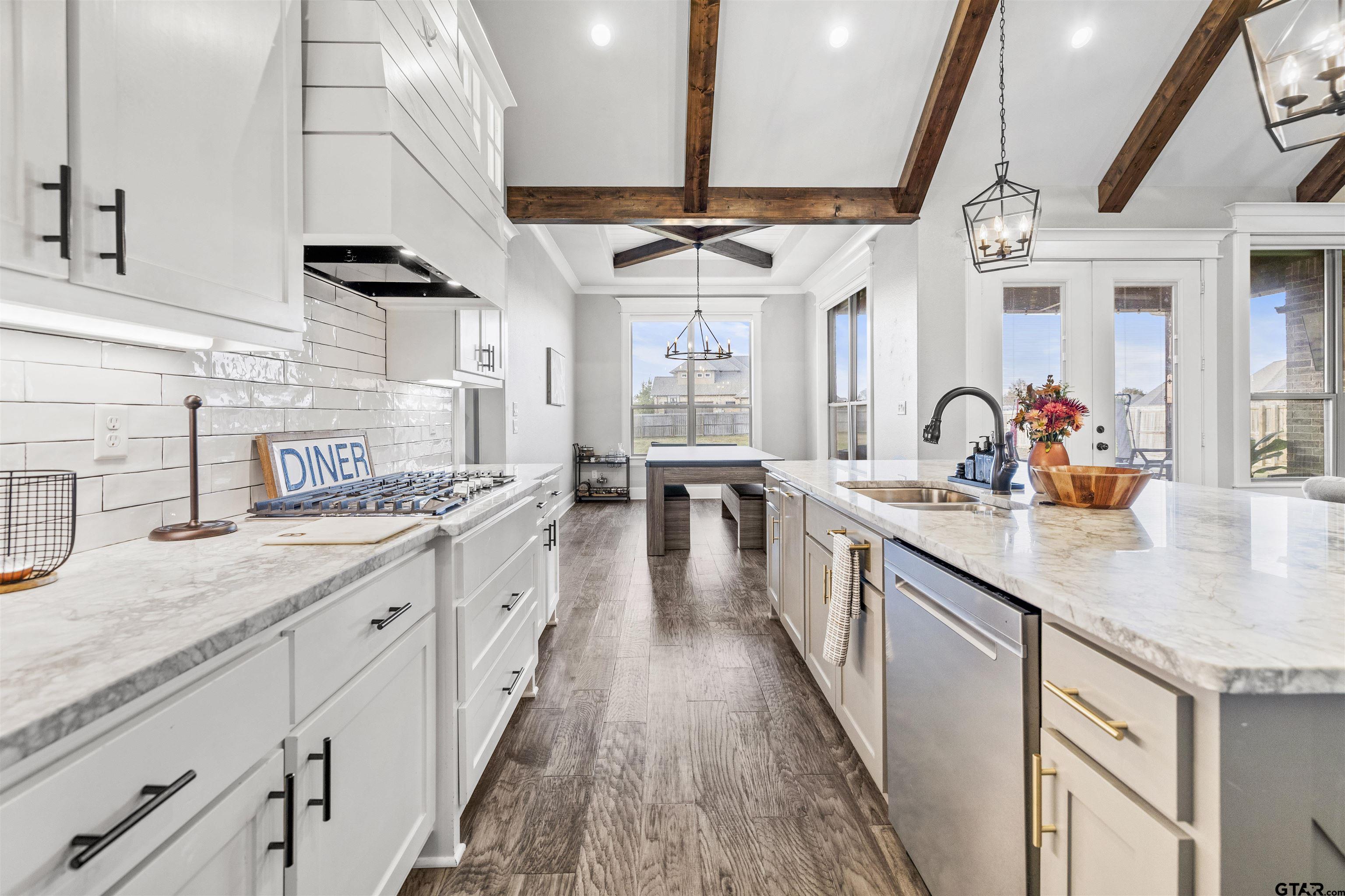 425 Coventry Street Bullard, TX 75757 - Photo 7 of 35 a large kitchen with stainless steel appliances kitchen island a large counter space a sink and a wooden floors