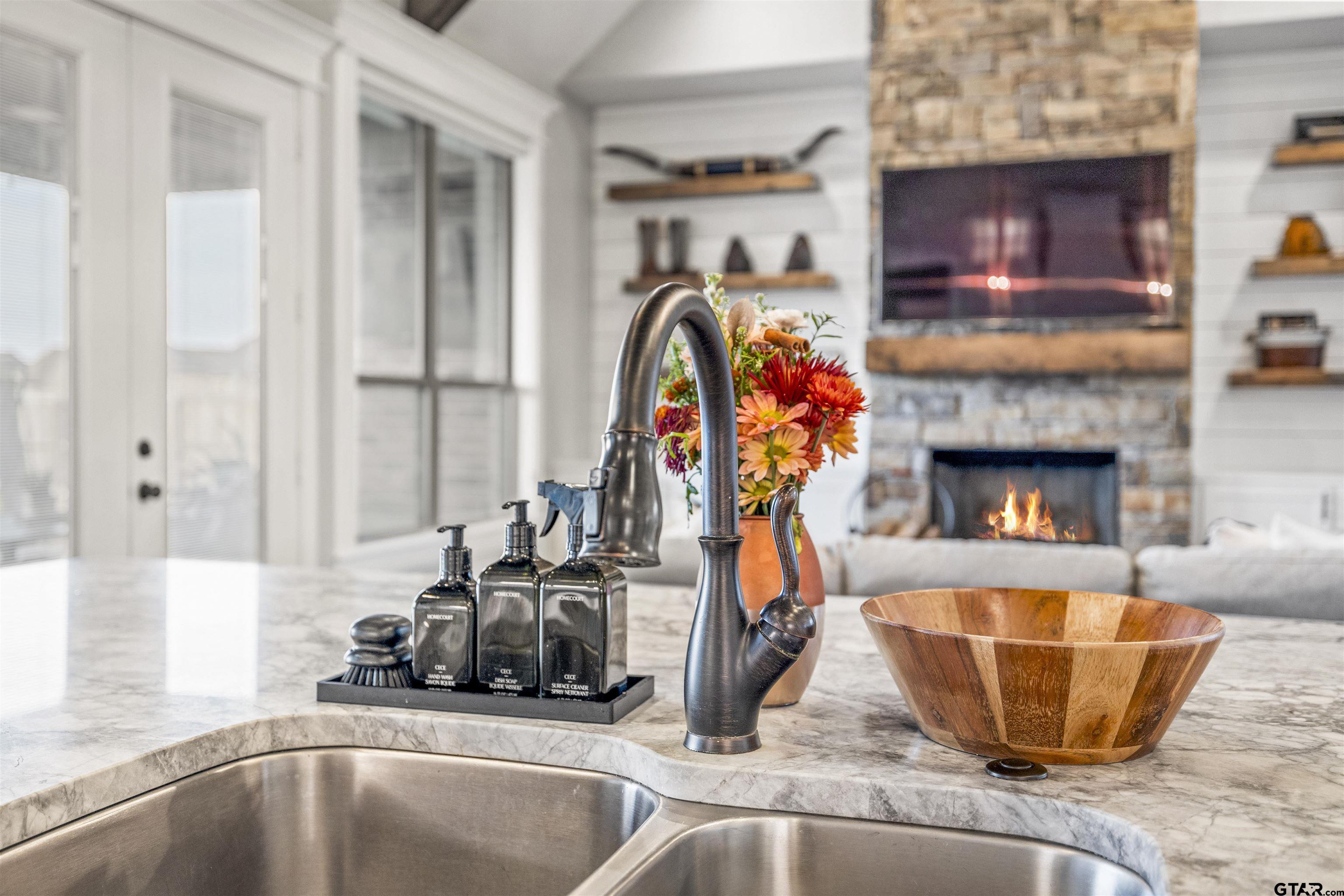 425 Coventry Street Bullard, TX 75757 - Photo 9 of 35 a view of a kitchen with a sink and a fireplace