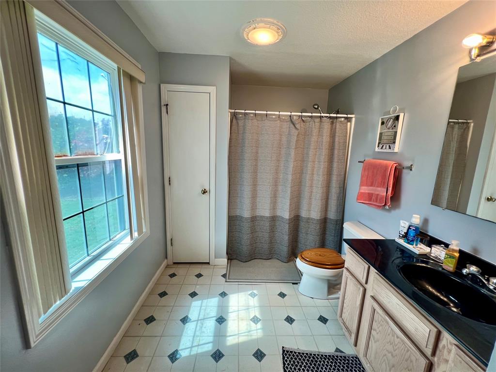 8971 Southeast 67th Drive Okeechobee, FL 34974 - Photo 11 of 14 a bathroom with a sink toilet and shower