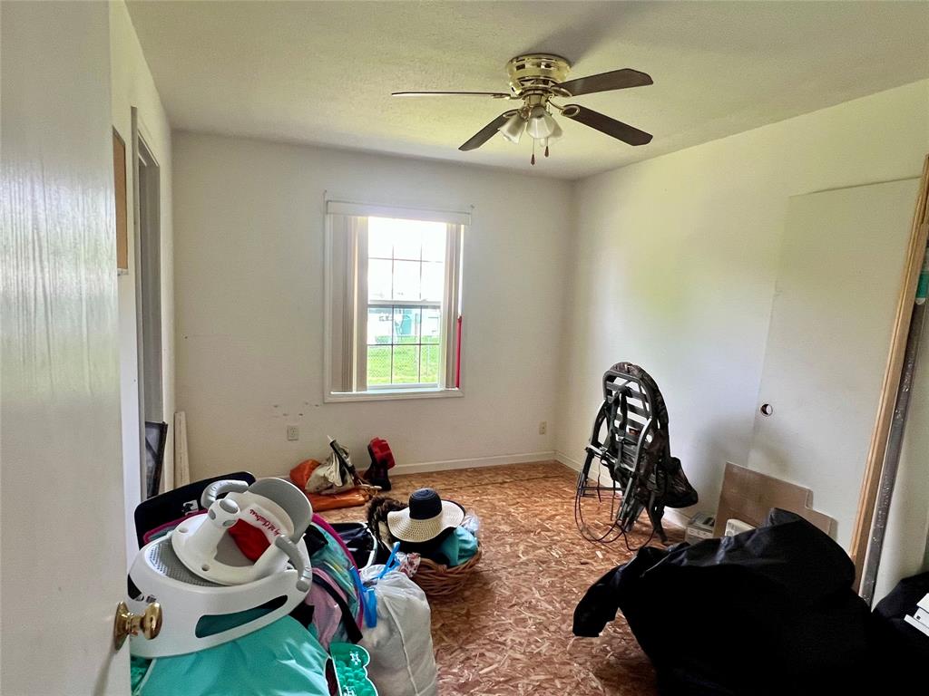 8971 Southeast 67th Drive Okeechobee, FL 34974 - Photo 12 of 14 a bedroom with a bed and a chandelier