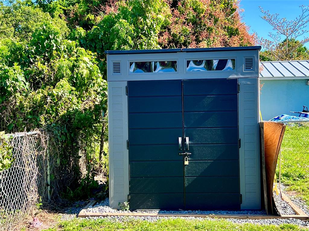 8971 Southeast 67th Drive Okeechobee, FL 34974 - Photo 14 of 14 a front view of a house with garden