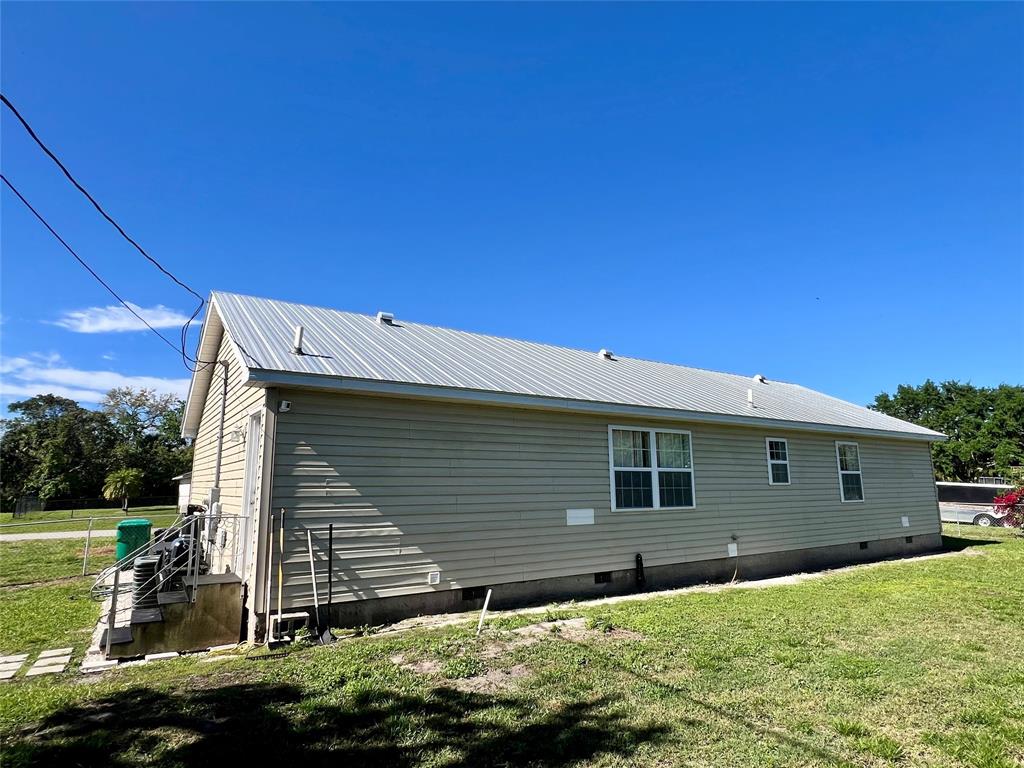 8971 Southeast 67th Drive Okeechobee, FL 34974 - Photo 3 of 14 a front view of a house with garden