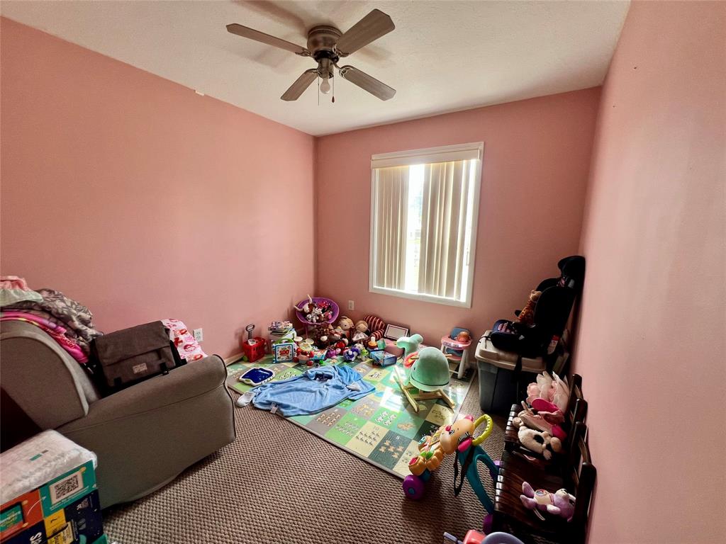 8971 Southeast 67th Drive Okeechobee, FL 34974 - Photo 9 of 14 a living room with furniture chess board and a window