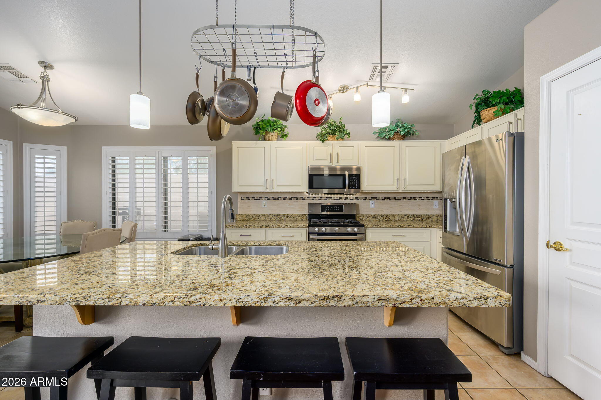 3136 East Roveen Avenue Phoenix, AZ 85032 - Photo 9 of 38 a kitchen with a table and chairs in it