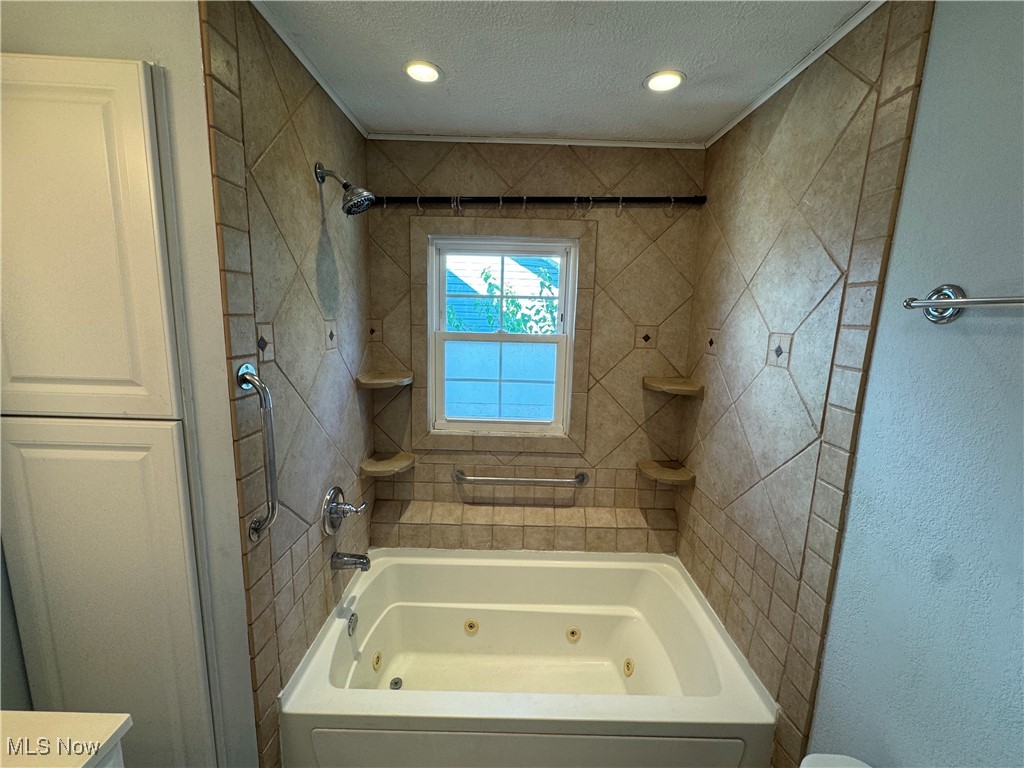 2425 7th Street Northwest Canton, OH 44708 - Photo 14 of 19 Full bath featuring a textured ceiling and a combined bath / shower with jetted tub