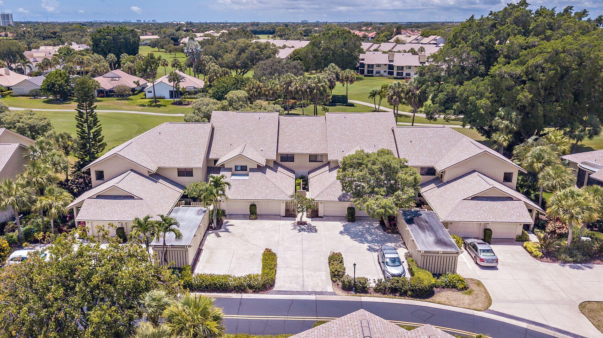 an aerial view of a house with a garden and lake view