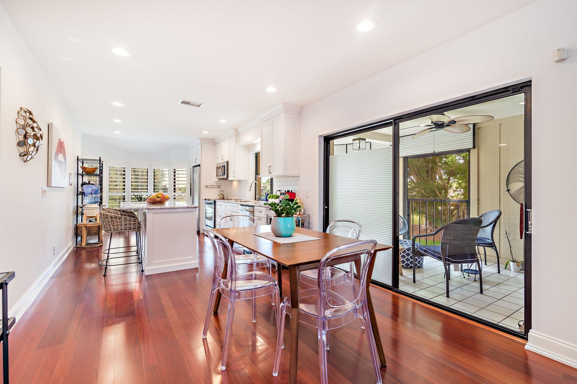 17138 Waterbend Drive, Unit 216 Jupiter, FL 33477 - Photo 6 of 20 a dining room with furniture window and wooden floor