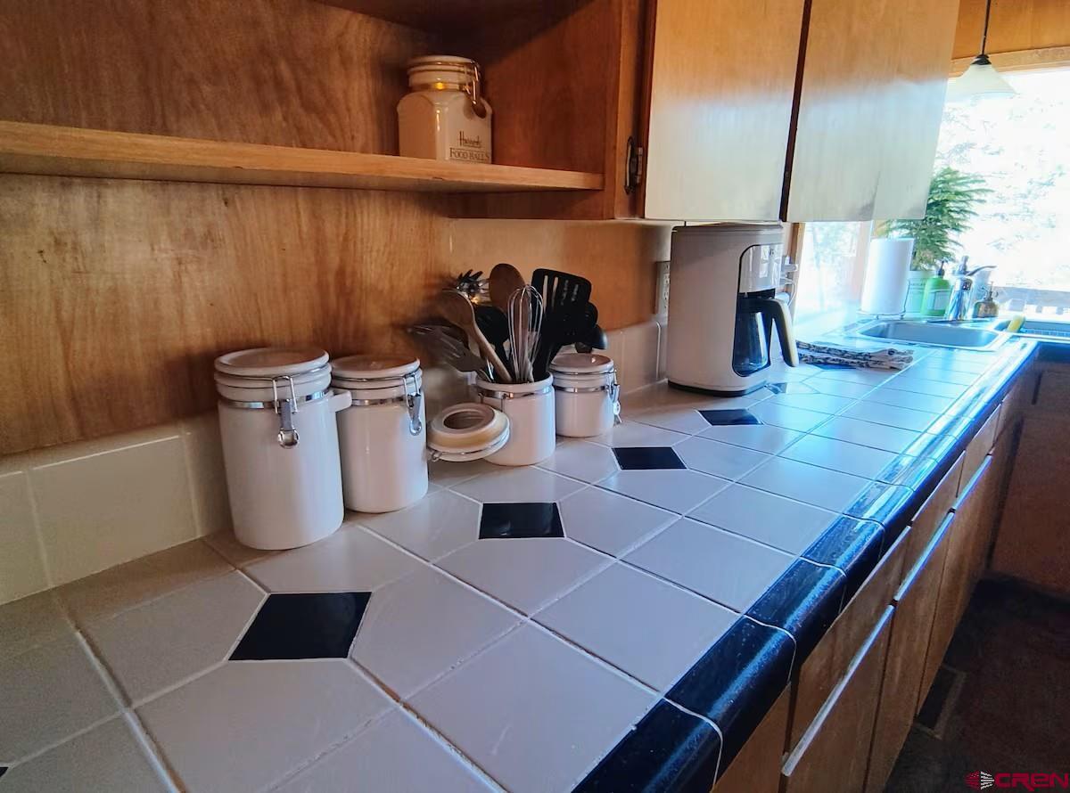 360 Sortais Road Durango, CO 81301 - Photo 15 of 36 a kitchen with a sink and cabinets