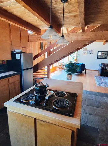 a kitchen with stainless steel appliances granite countertop a sink a stove and a refrigerator